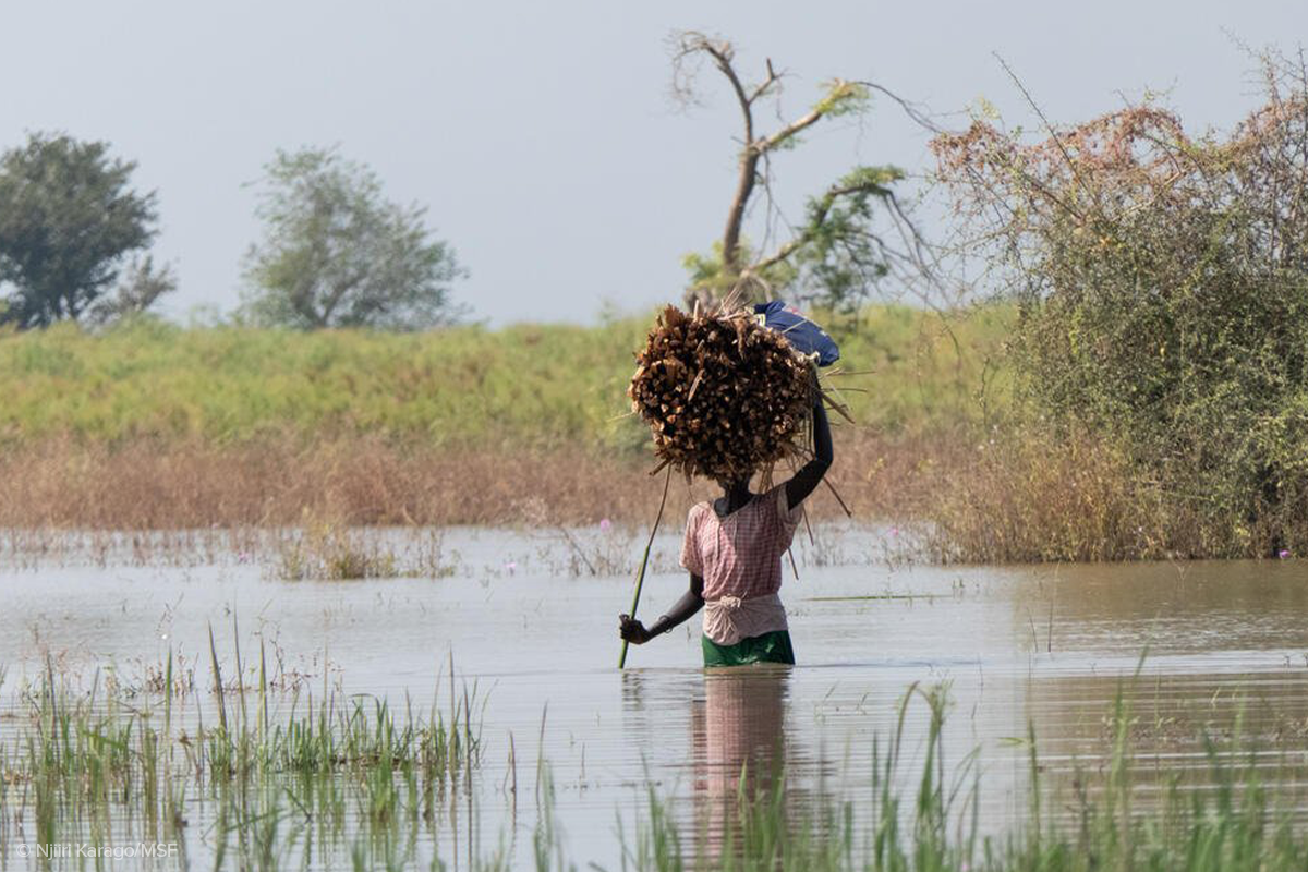 A woman wades through floodwaters near Bentiu in South Sudan’s Rubkona county to collect firewood